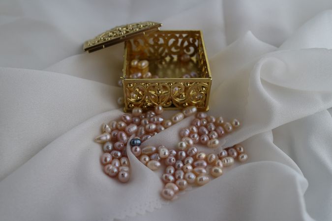 Freshwater pearls scattered on satin silk