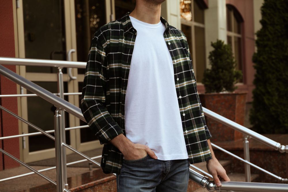 Men in blank t-shirt and green checkered shirt, space for text