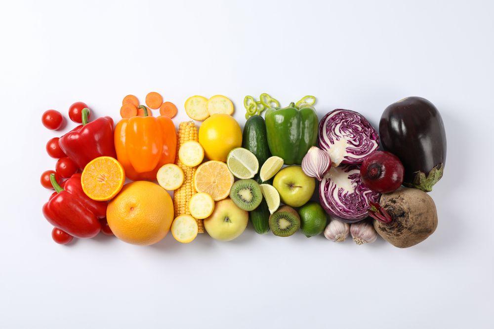 Flat lay with different vegetables and fruits on plain background, copy space