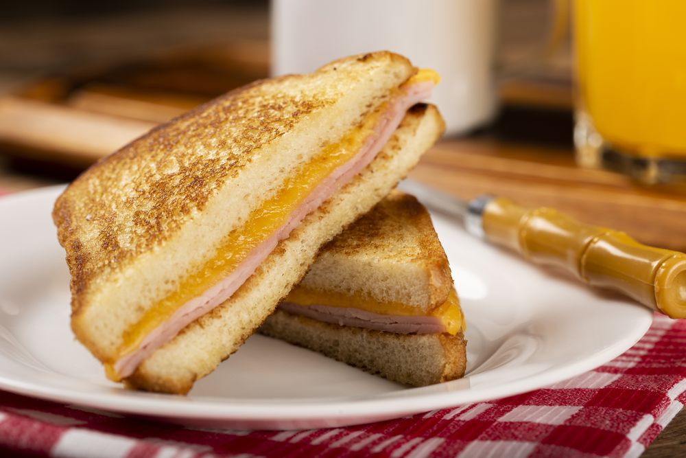 Grilled ham and cheese. Sandwich with cheese and ham on grill.