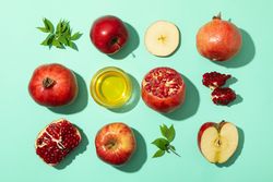 Top view of autumnal fruit scattered on mint background