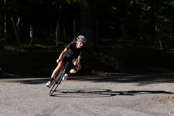 Professional cyclist riding bike in park