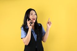 Young Asian Business Woman Have an Bright Idea While making a Phone Call