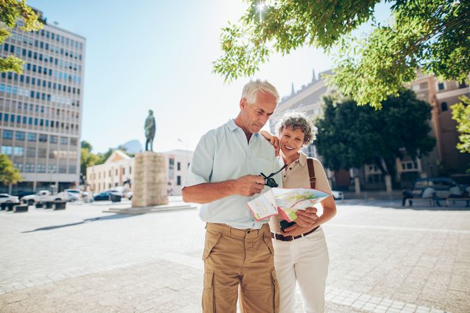 Couple using a city map looking for a location in the town