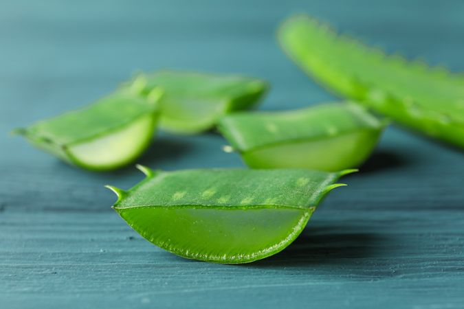 Aloe vera slices on wooden table, closeup and space for text. Natural treatment