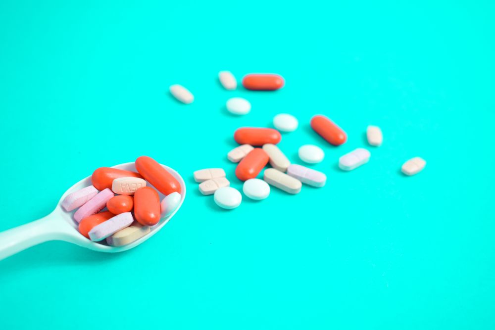 Spoon with colorful tablets
