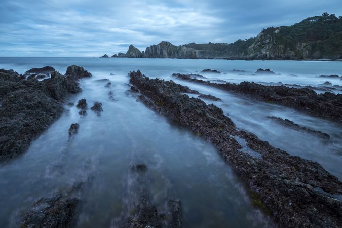 Foggy landscape of Playa de Gueirua rock seashore