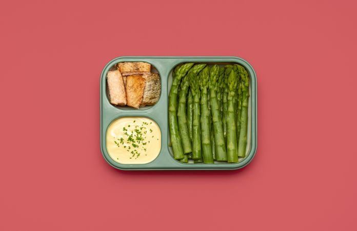 Prep meal, lunch box top view isolated on a pink background