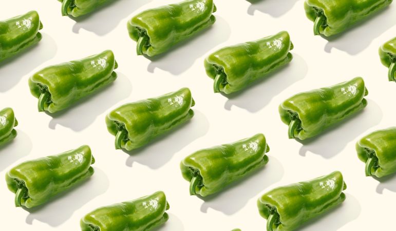 Rows of whole green peppers