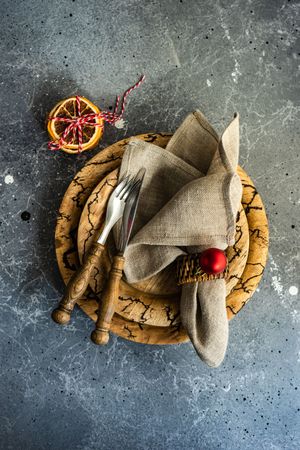 Top view of rustic Christmas table setting with decorative dried orange slices