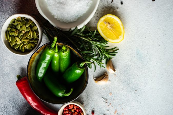 Bowl of peppers surrounded by other flavorful ingredients