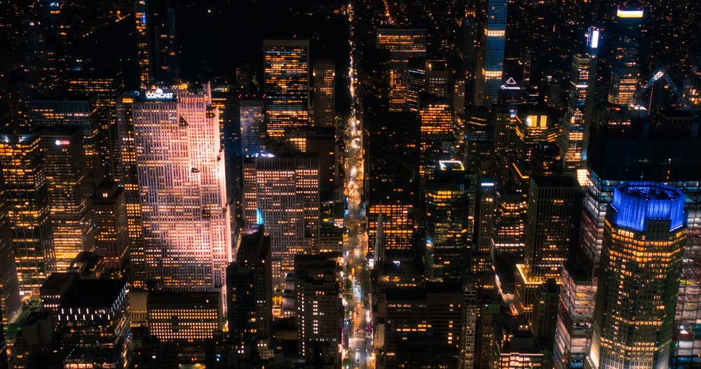 Scenic Aerial New York City View of Downtown Manhattan Architecture. High Angle Night Shot of the Business District from a Helicopter. Cityscape with Office Buildings and Busy Traffic on Streets