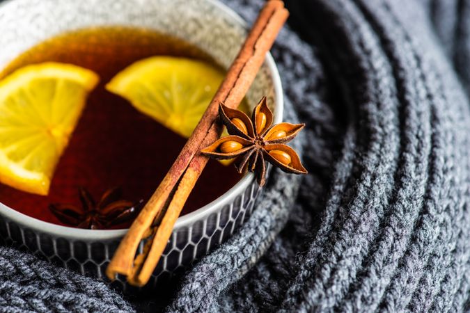 Close up of star anise and cinnamon balancing on tea cup