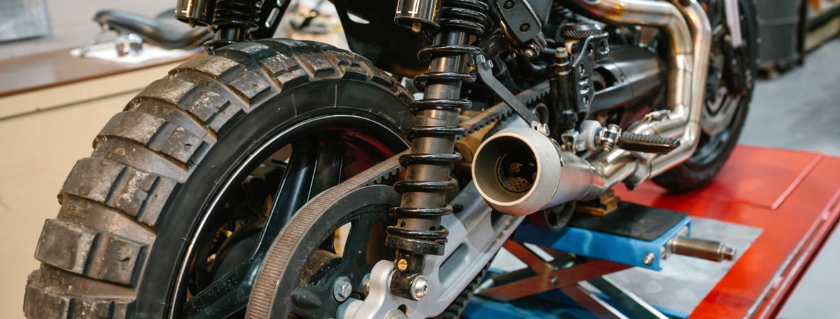 Banner of exhaust pipe and shock absorber of custom motorbike on factory