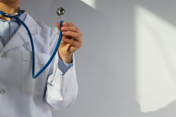 A stethoscope in the hands of a doctor