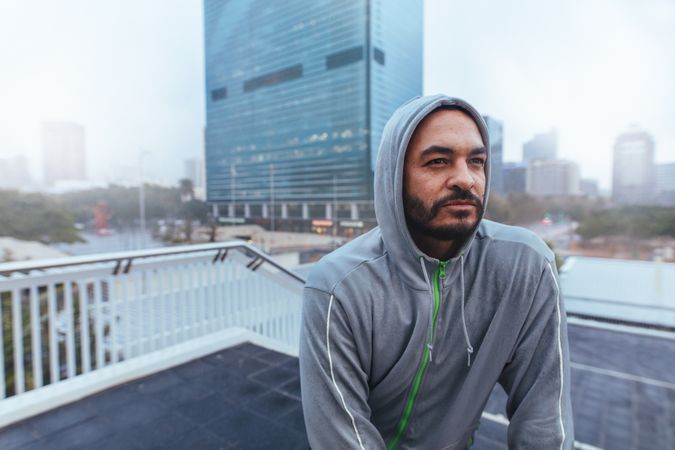 Portrait of a male runner in hooded sweatshirt