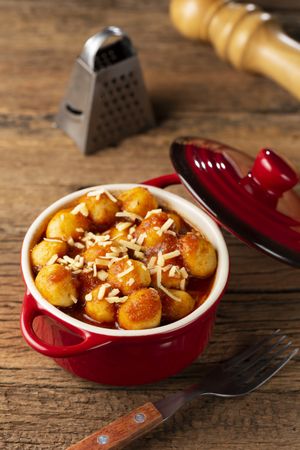 Gnocchi with tomato sauce and grated Parmesan cheese.