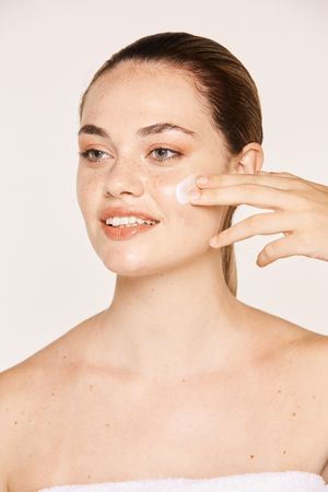 Amiable female taking care of face