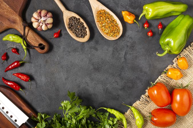 Ingredients for cooking with tomatoes, various peppers, garlic and green peppers.
