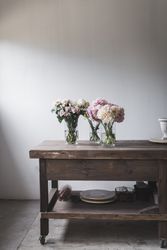 Bunches of flowers in vases on table