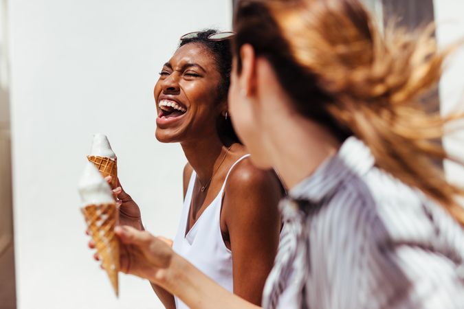 Two friends smiling with ice cream