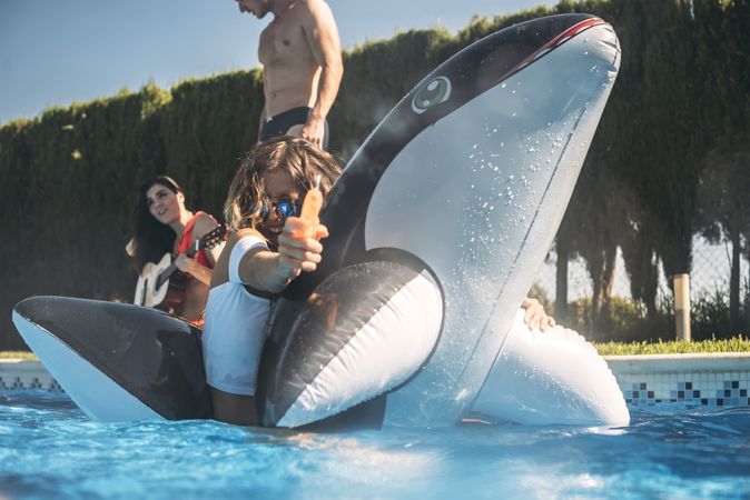 Woman swimming and using water gun