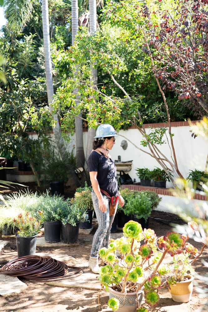 Woman in hard hat outside in garden