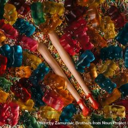Doll legs buried in colorful sprinkles and gummy bears 0LPaP0