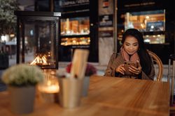 Asian traveler using smartphone in cafe