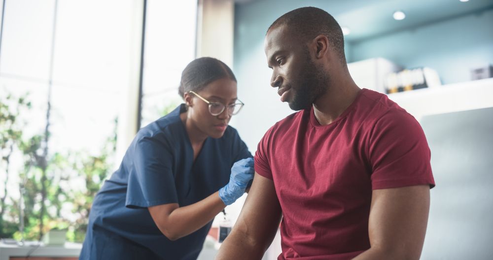 Professional Black Female Nurse Is Performing Injection And Putting Patch On. Public Healthcare Concept