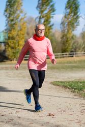 Older male speed walking in park
