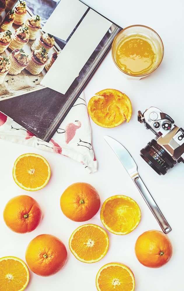 Arrangement of oranges and photo camera