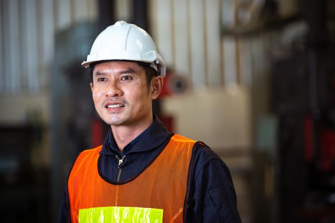 Portrait of Asian man smiling in factory