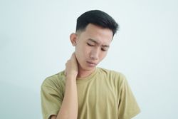 Close up Asian young man touching neck in pain