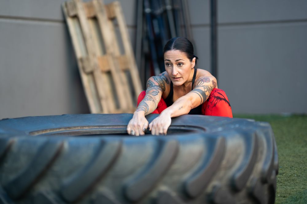 Woman working out with tire