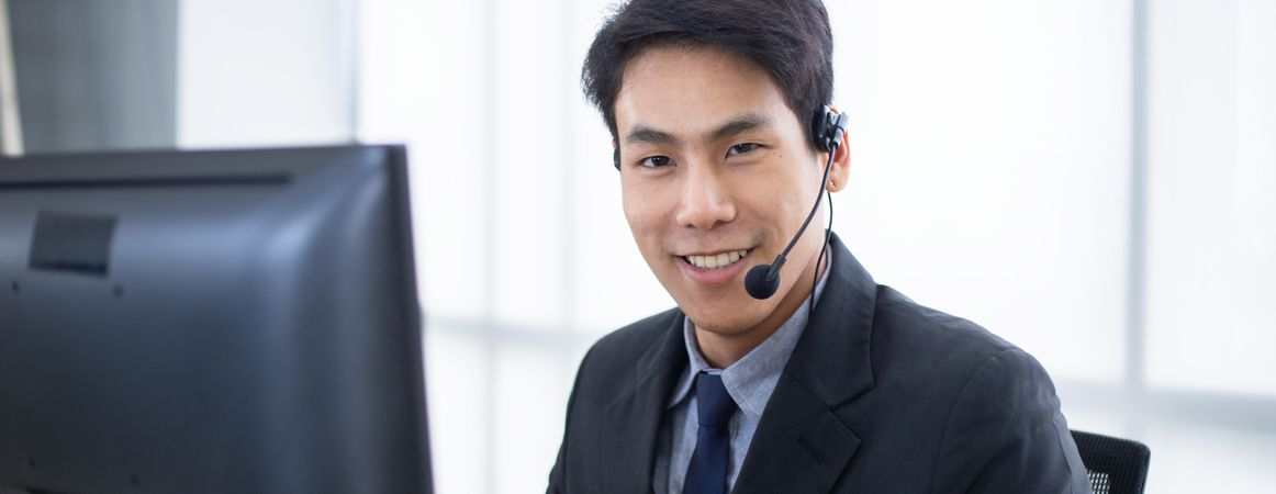 Banner of smiling man at work wearing headset