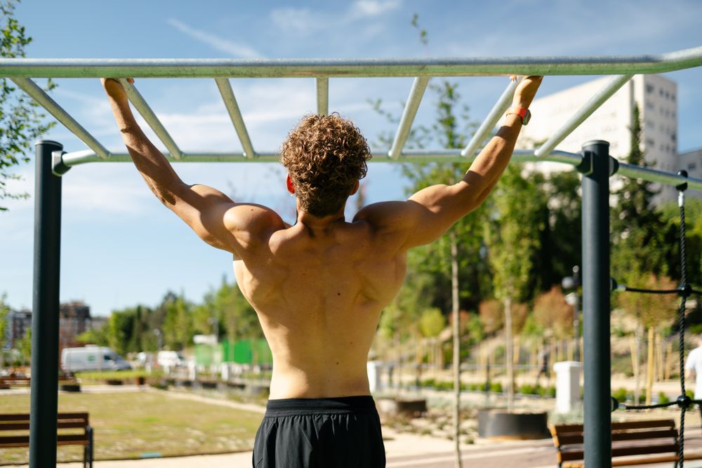 Strong young sportsman doing calisthenics