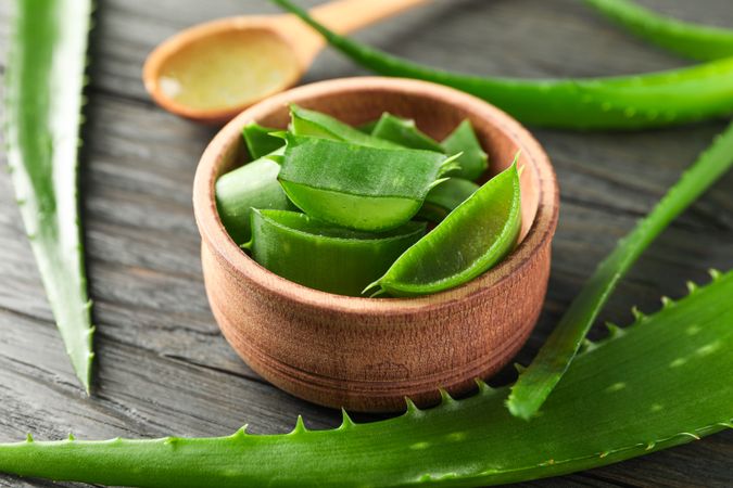 Aloe vera leaves and slices on wooden table, closeup. Natural treatment