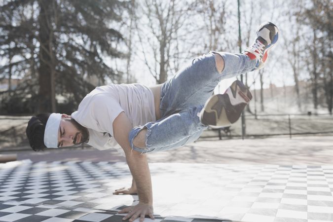 Man dancing break dance in park