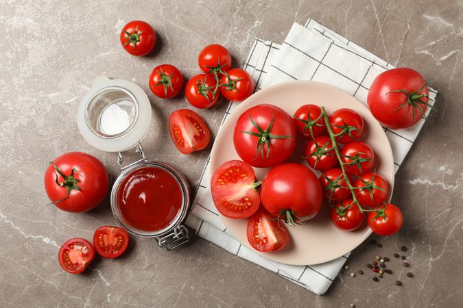 Composition with tomatoes on gray background, top view