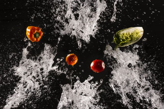 Flying fresh vegetables in splashes of water
