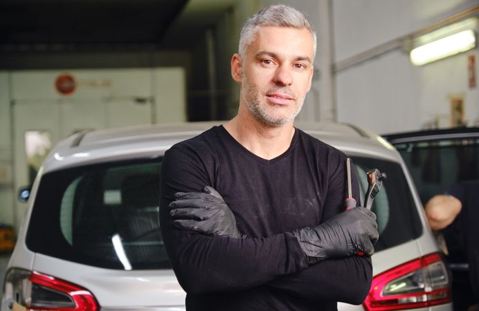 Confident mechanic in garage