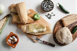 Dough near corn husk and spices for tamales