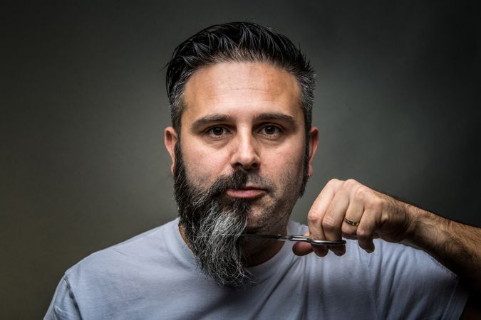 Expressive barber cutting beard