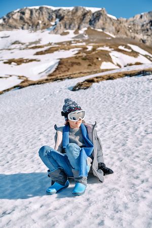 Boy on snowy hill in ski sunglasses