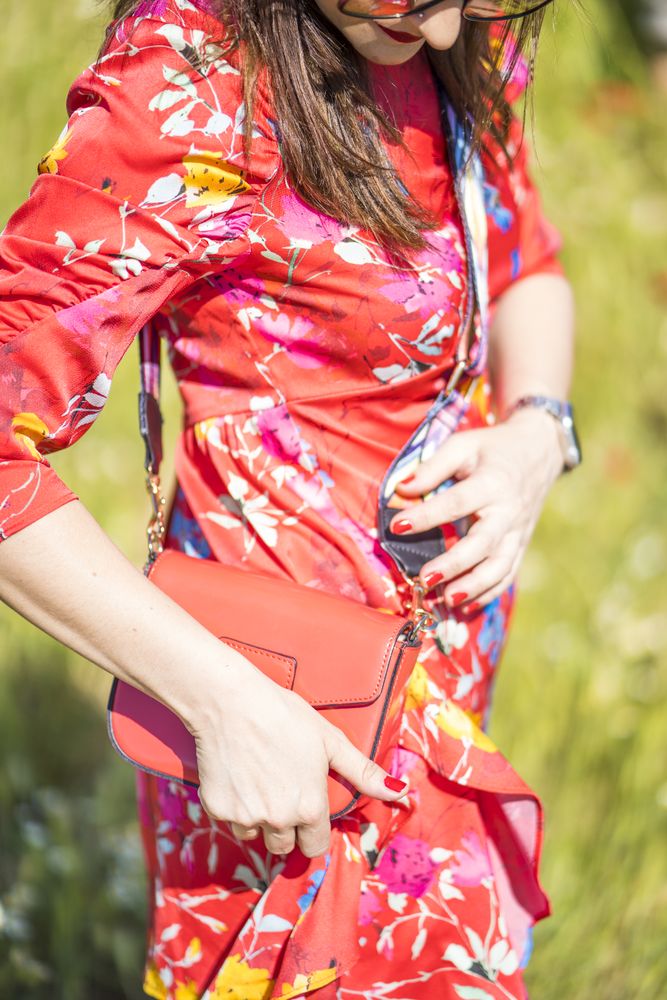 Crop female with bag standing in summer field