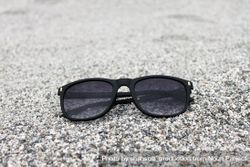 Sunglasses on grey sand 4j33Wb