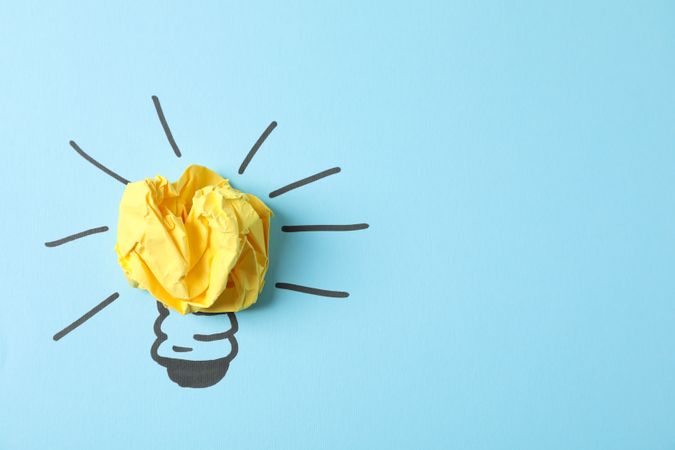 Drawn light bulb and paper ball on blue background. Good idea concept