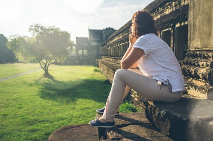 Female tourist looking at old temple