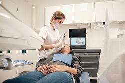 Dentist making 3D scan of unrecognizable woman